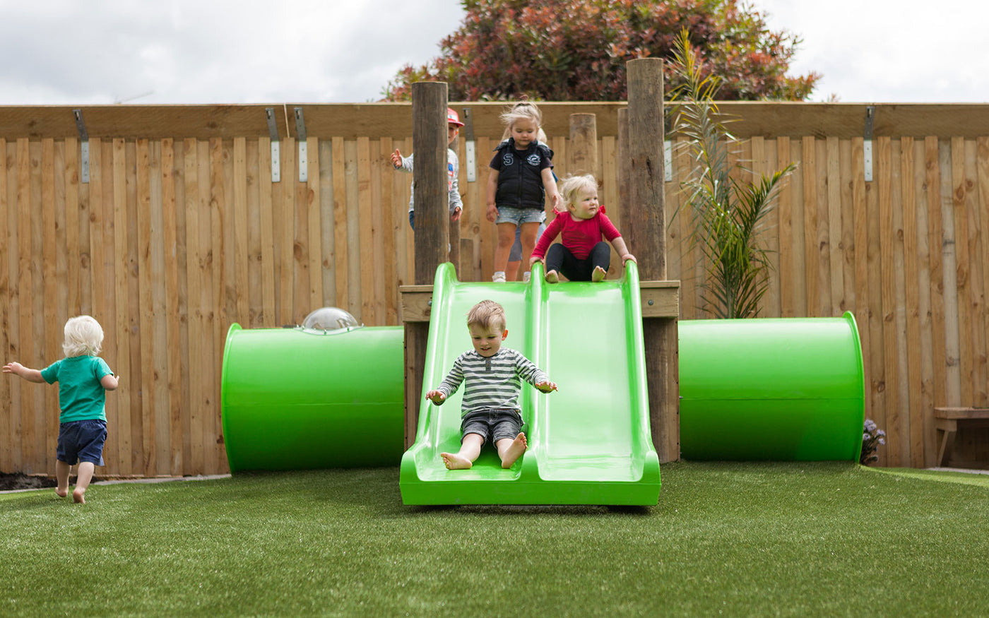 Kids at Tadpoles playing on the slide