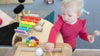 Toddler playing with wooden toys at Tadpoles Early Childhood Centre