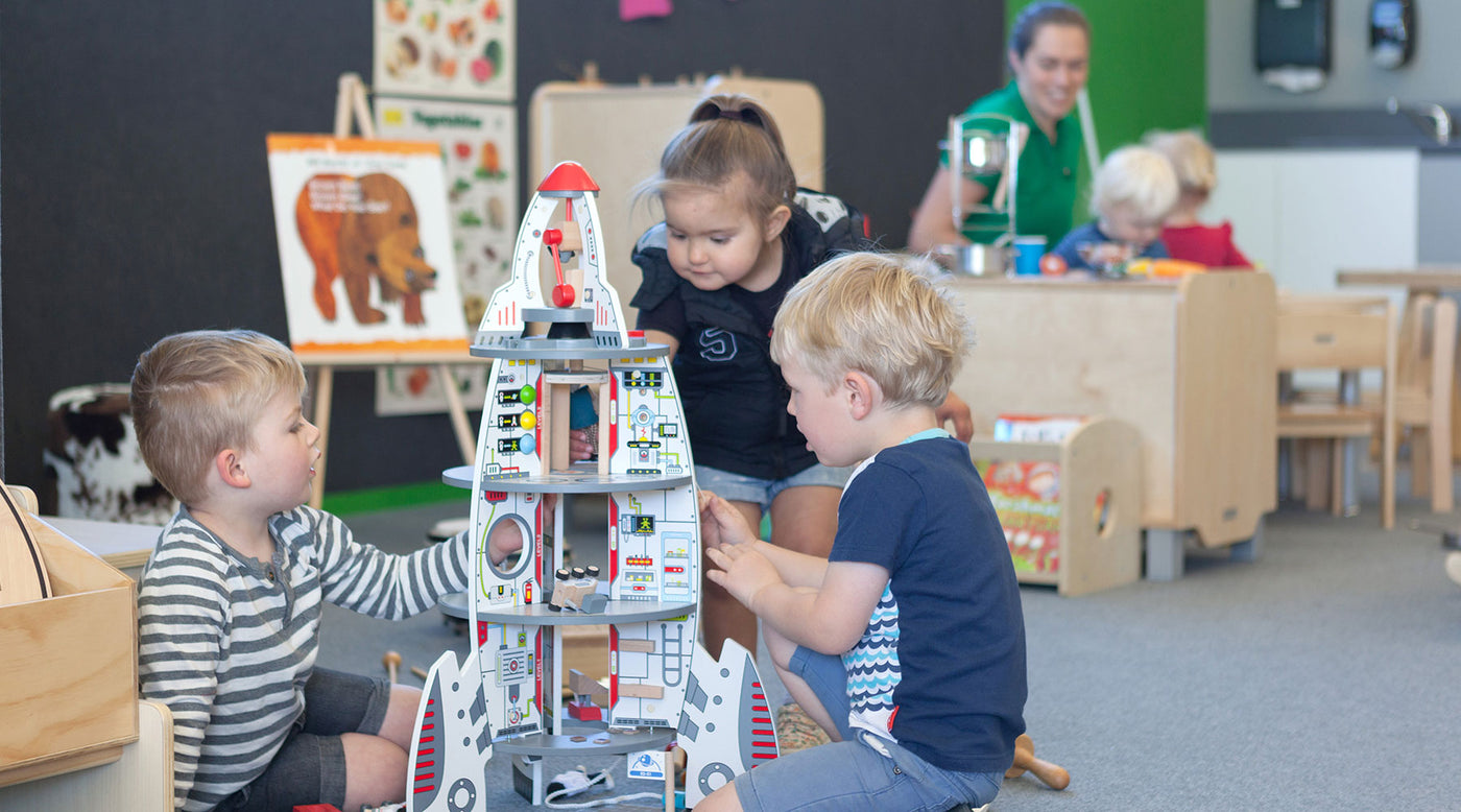 Preschoolers at Tadpoles Early Childhood playing with a rocketship