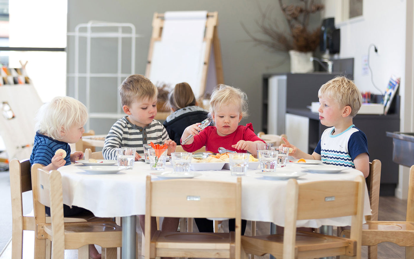 Four toddlers eating morning tea at Tadpoles Early Childhood Centre